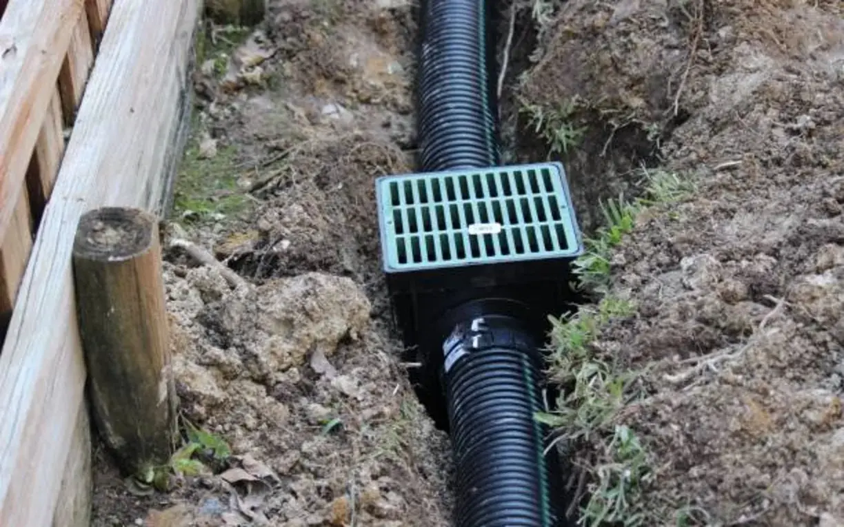 Yard catch basin and corrugated drainage pipe installed in a residential trench